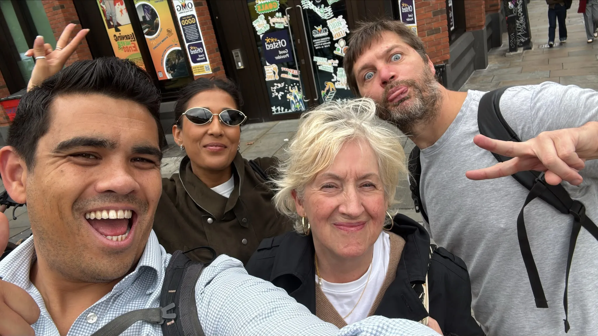 Four players smiling and posing for a group selfie during a Lost Elephant game